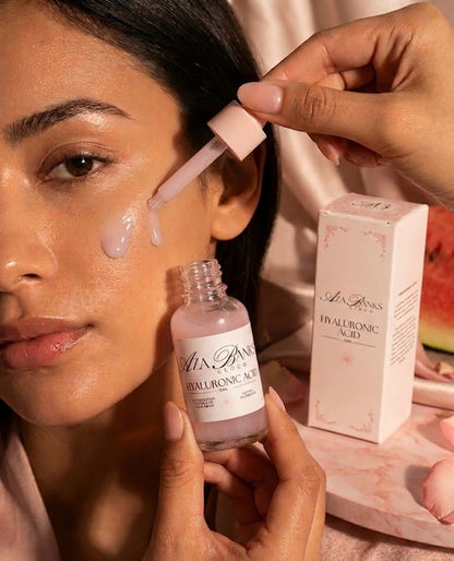 Person applying skincare product with a dropper.